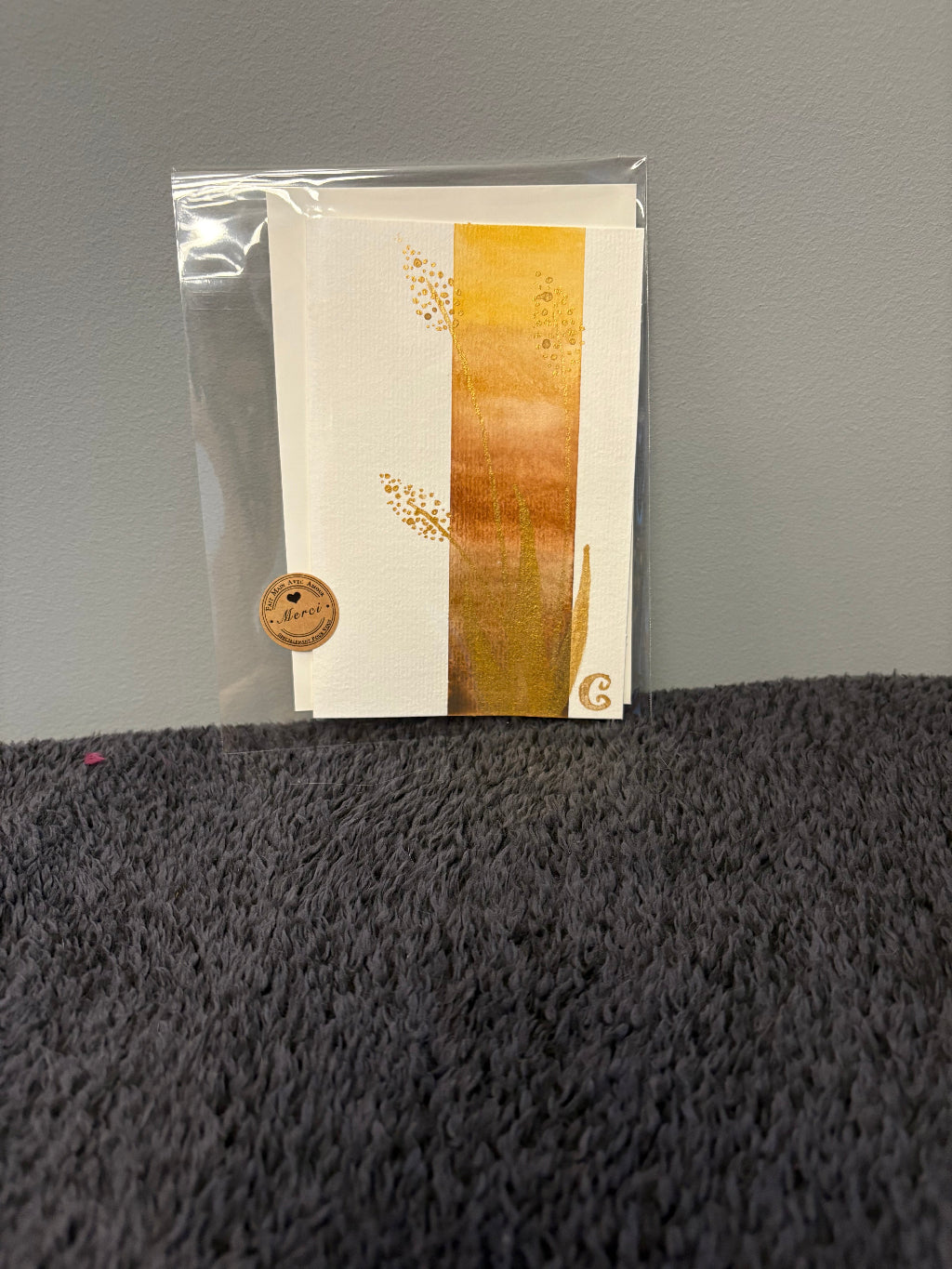 Card with floral design in a clear plastic sleeve 