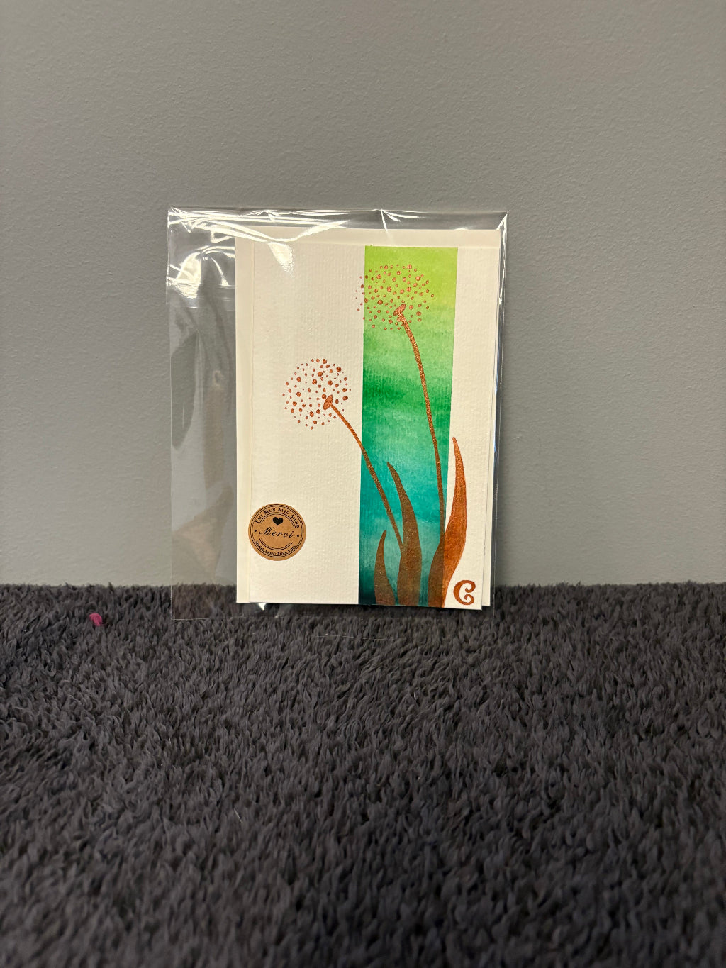 Card with floral design in a clear plastic sleeve 