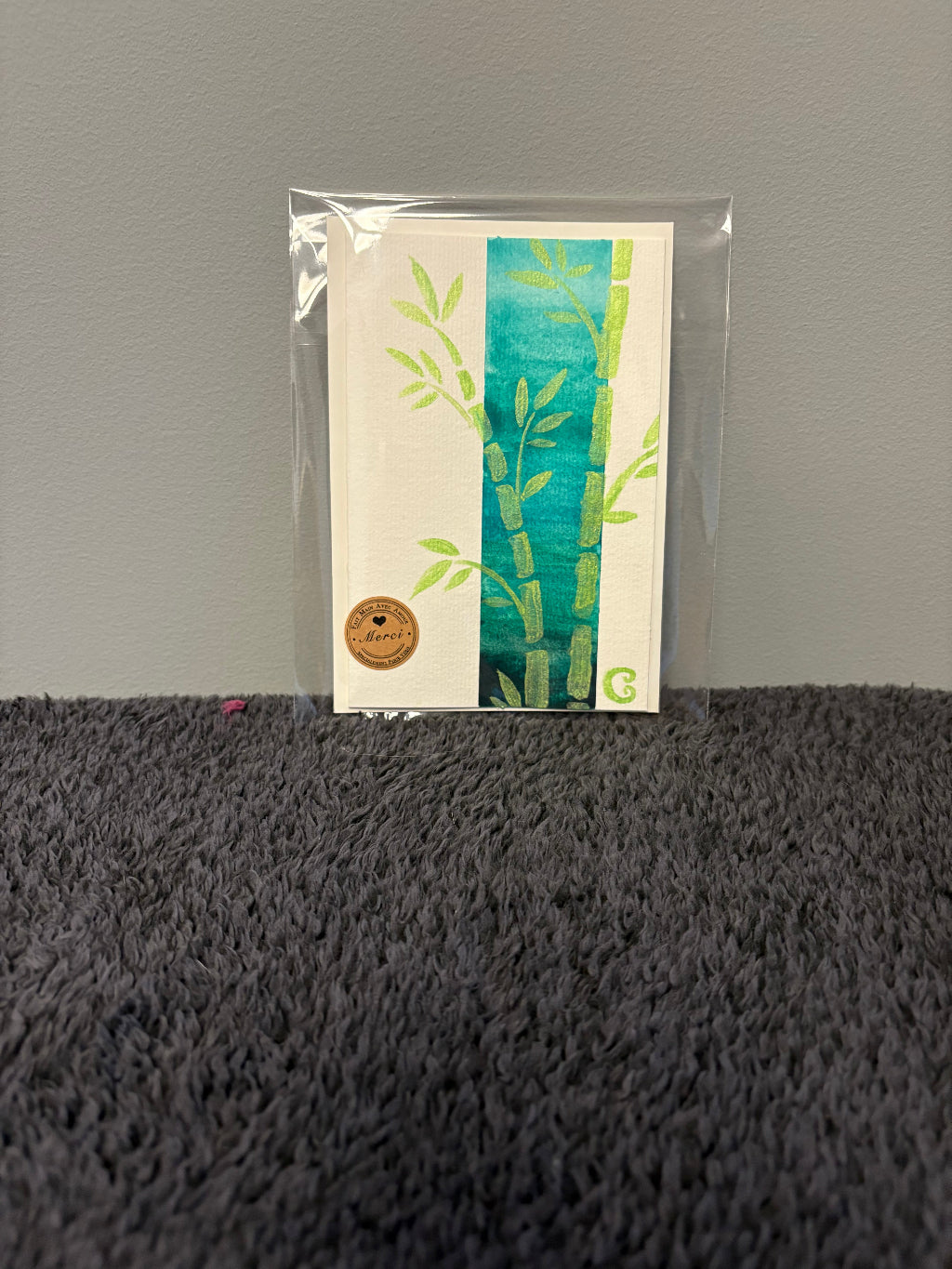 Card with floral design in a clear plastic sleeve 