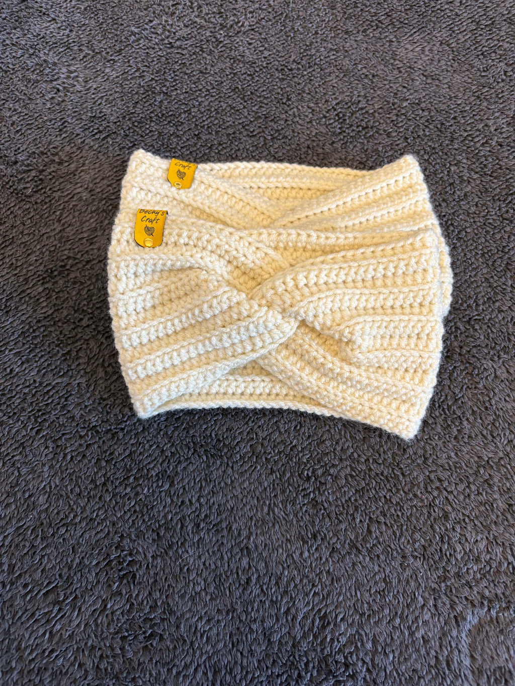 White knitted product with yellow labels on a gray textured surface
