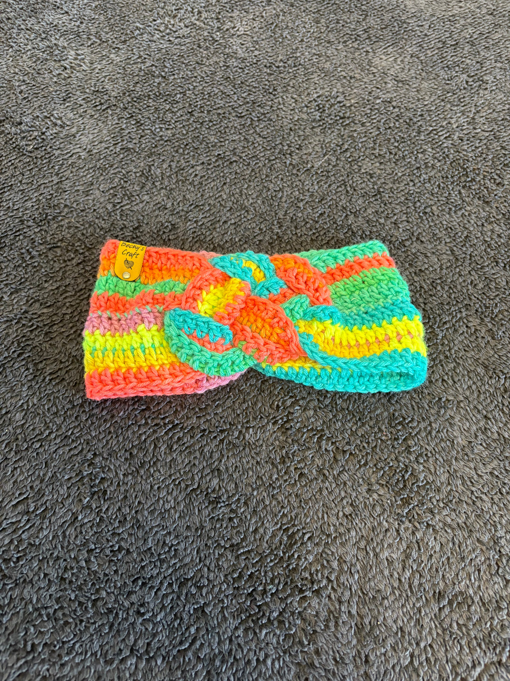 Colorful knitted Headband on a gray surface
