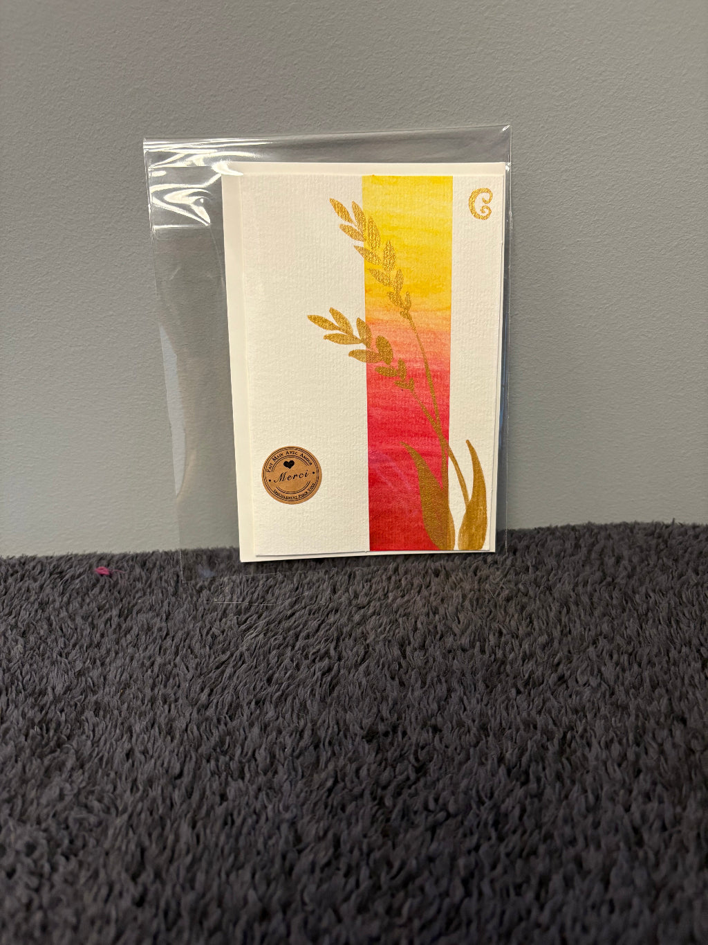 Card with floral design in a clear plastic sleeve 