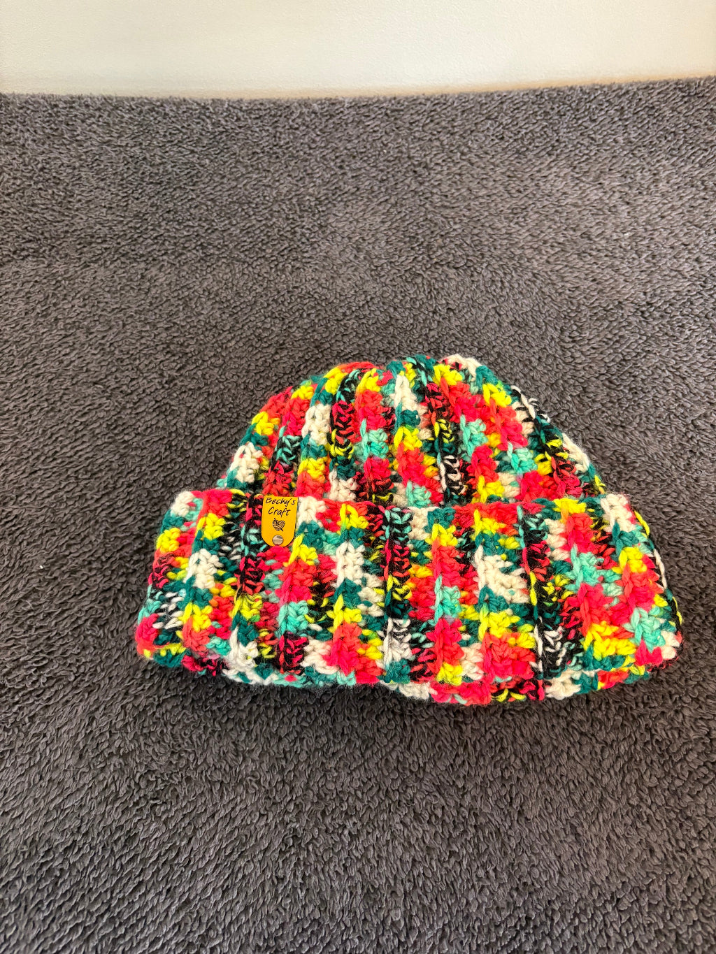 Colorful patterned Beanie on a gray surface
