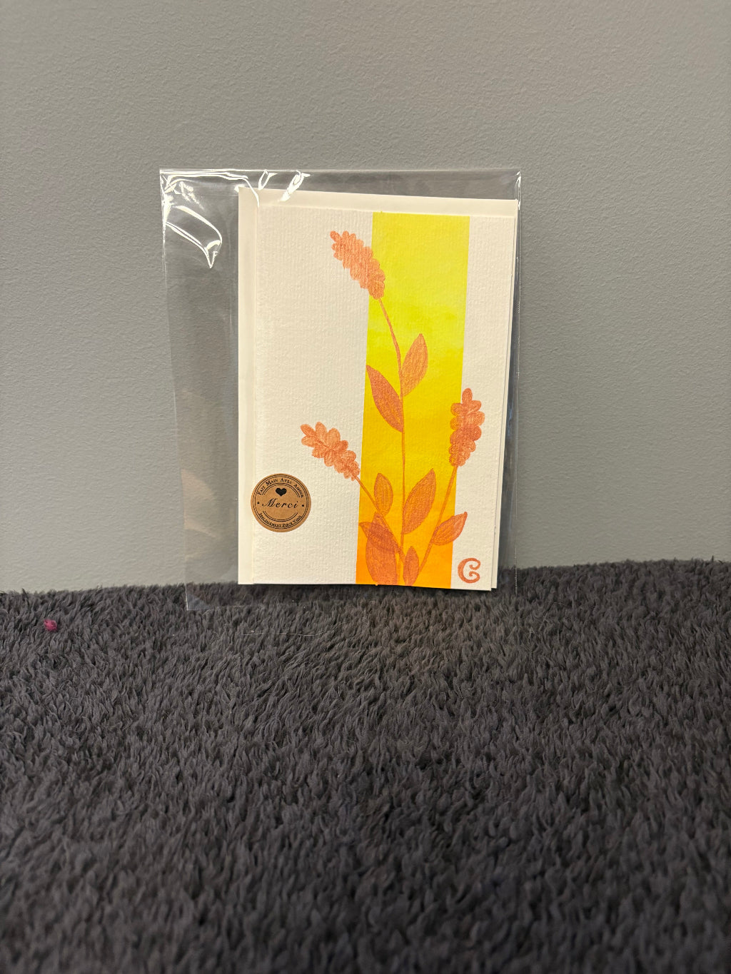 Card with floral design in a clear plastic sleeve 